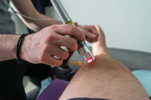 Laser therapy on a knee used to treat pain selective focus