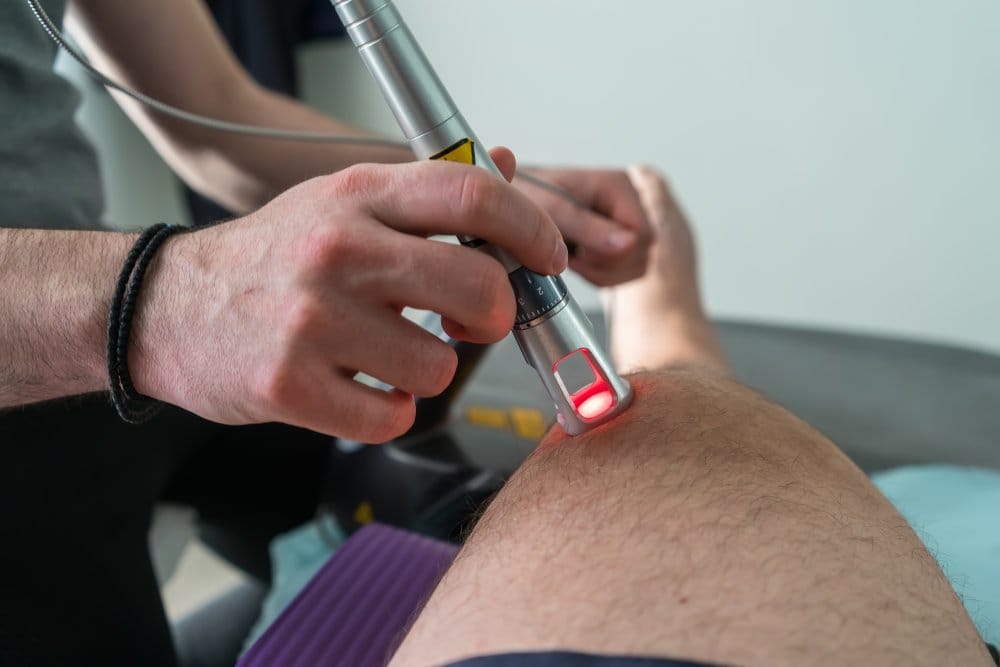 Laser therapy on a knee used to treat pain selective focus